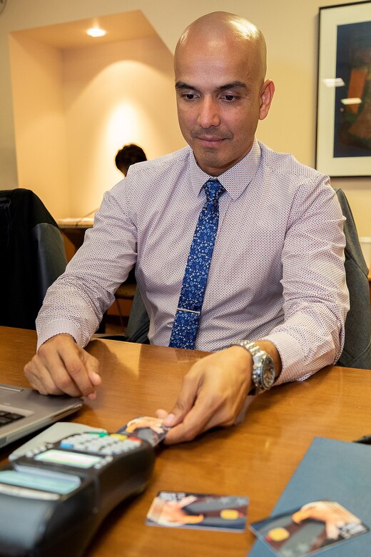 U.S. Marine Chief Warrant Officer Timothy Taylor, Regional Disbursing Office West expeditionary fiscal officer, trains on a point-of-sale device used to process EagleCash payments during a U.S. Army Financial Management Command and Federal Reserve Bank of Boston-hosted training session at the Federal Reserve Bank of Boston May 8, 2019.