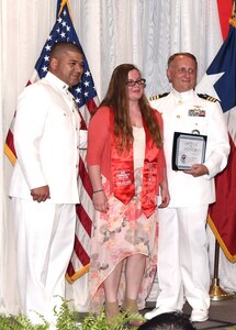 Navy Cmdr. Jeffrey Reynolds, commanding officer, Navy Recruiting District San Antonio, and Command Master Chief  Francisco Valdovinos delivered certificates and challenge coins to 36 future Sailors, who were honored during “A Night in Your Honor” hosted by Our Community Salutes-San Antonio in the Rosenberg Sky Room at the University of the Incarnate Word May 15.