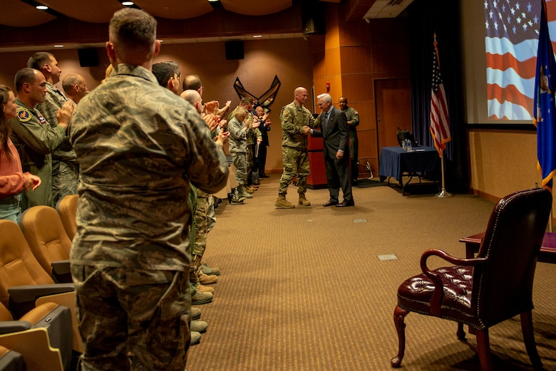 Team Offutt gives a standing ovation to guest speaker, retired Air Force Lt. Col. Barry Bridger, May 16, 2019, at Offutt Air Force Base, Nebraska. Bridger is a Vietnam Veteran and Prisoner of War for six years at the Hoa Loa prisoner of war camp.