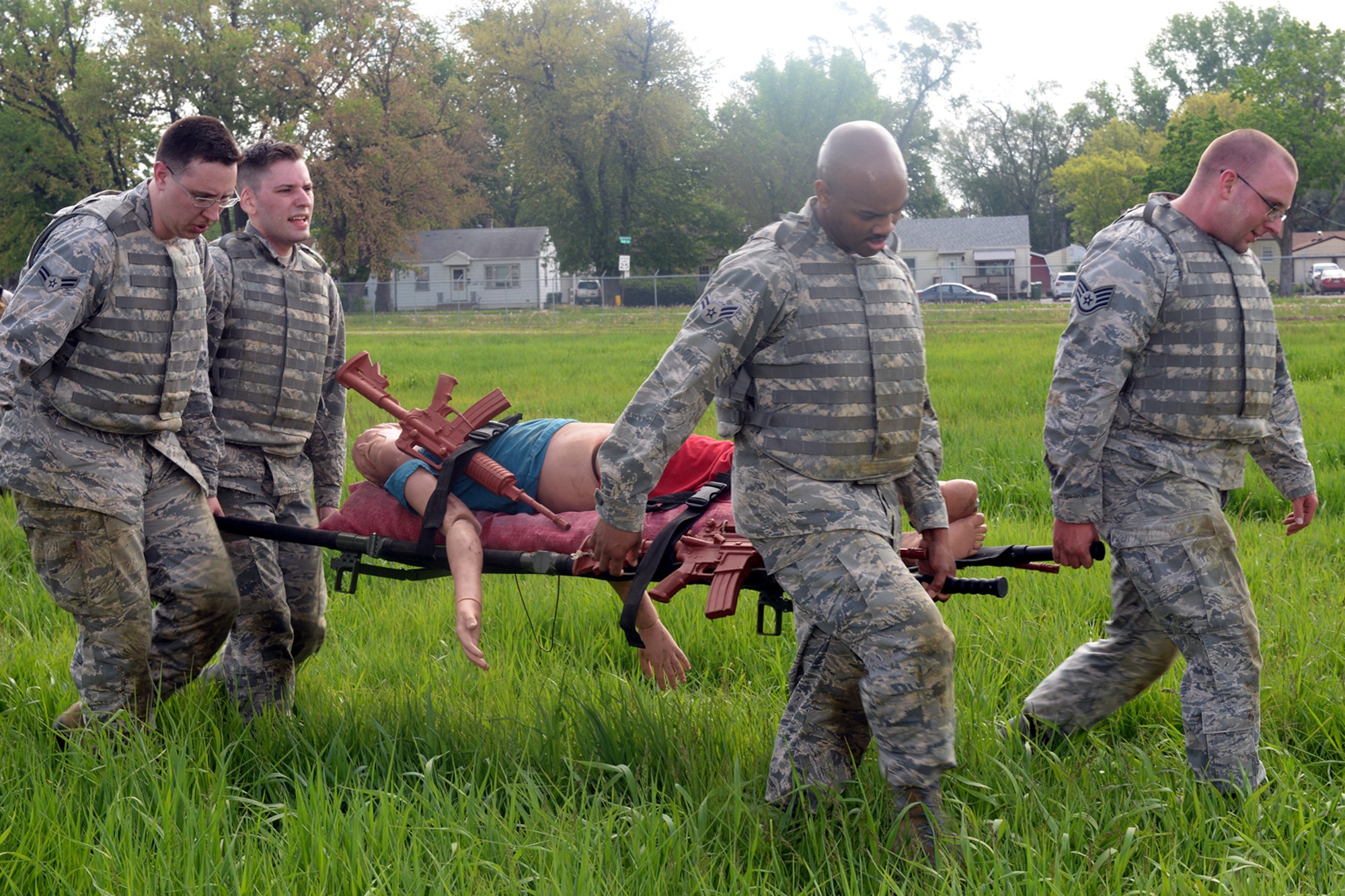 Participants of the Raider Challenge perform a casualty evacuation carrying 50 pounds of sandbags through an obstacle course May 15, 2019, at Offutt Air Force Base, Nebraska. In 1962, President John F. Kennedy signed a proclamation which designated May 15 as Peace Officers Memorial Day and the concurrent week as Police Week. (U.S. Air Force photo by Kendra Williams)