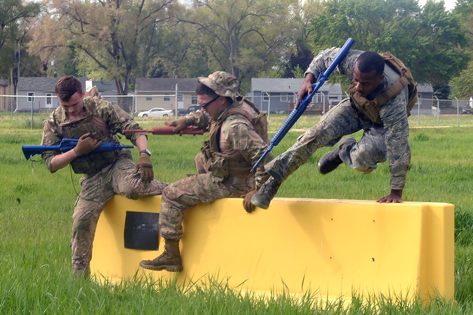Raider Challenge participants jump over a barrier during the Police Week Warrior challenge May 15, 2019, at Offutt Air Force Base, Nebraska. The event was a test of physical endurance, strength, ability, and resolve.  (U.S. Air Force photo by Kendra Williams)
