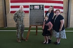 Col. Parks Hughes (left), Special Warfare Training Wing commander, present a plaque to the family of Senior Airman Bradley Smith, a fallen Special Tactic Airman and Silver Star recipient, during a dedication ceremony April 19 at Joint Base San Antonio-Lackland Medina Annex, Texas.