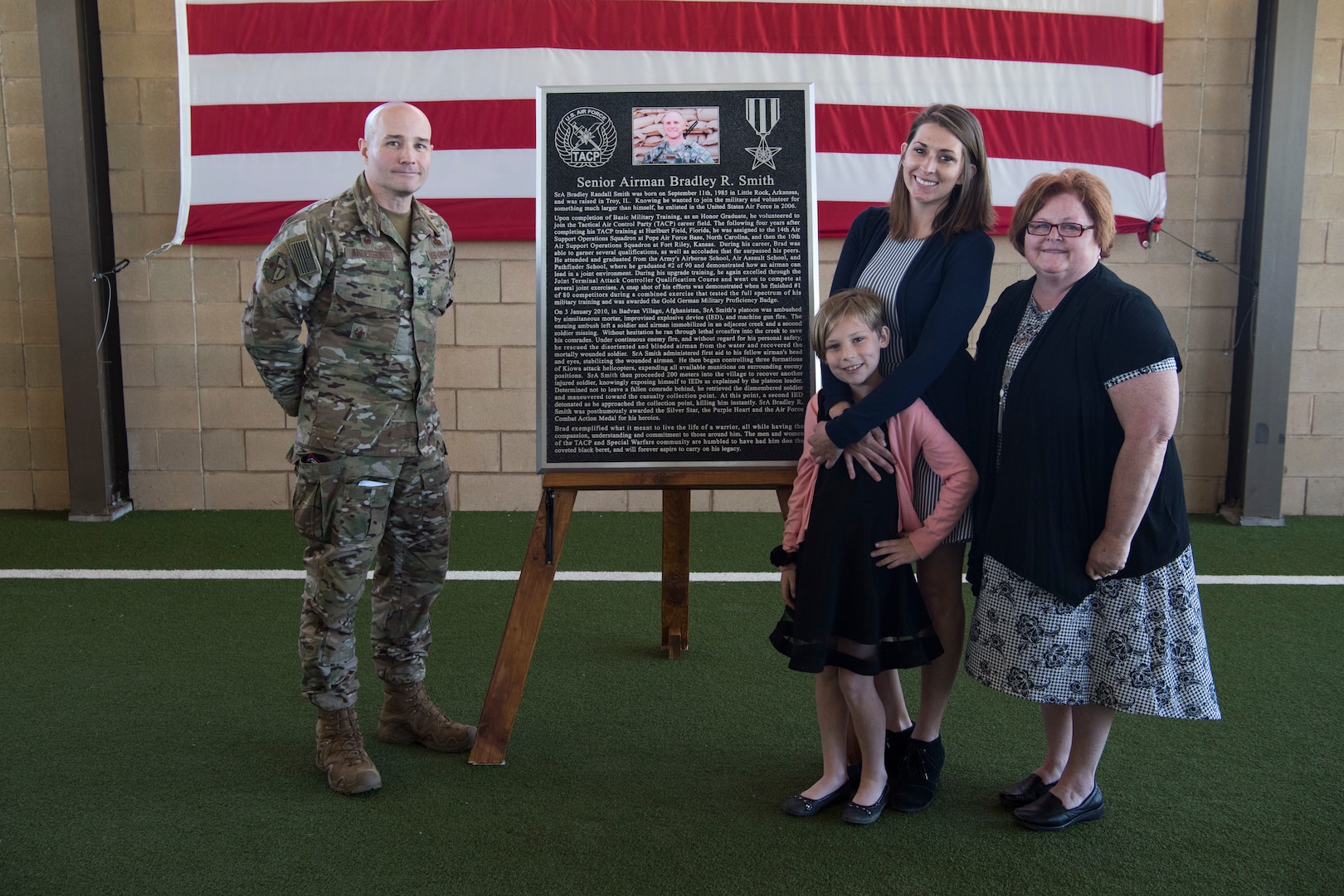 Col. Parks Hughes (left), Special Warfare Training Wing commander, present a plaque to the family of Senior Airman Bradley Smith, a fallen Special Tactic Airman and Silver Star recipient, during a dedication ceremony April 19 at Joint Base San Antonio-Lackland Medina Annex, Texas.