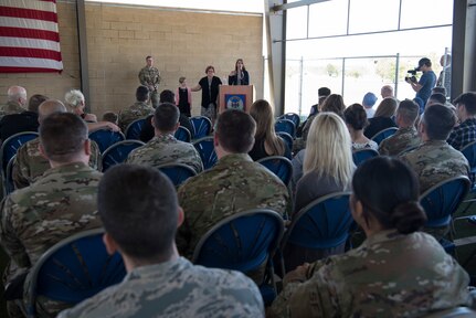 Paula Smith (right), mother of Senior Airman Bradley Smith, a Silver Star recipient, provides remarks while Smith’s wife, Tiffany Smith (center) and daughter, Chloe Smith (left), 9, look on during a dedication ceremony in Smith’s honor at Joint Base San Antonio-Lackland Medina Annex, Texas.