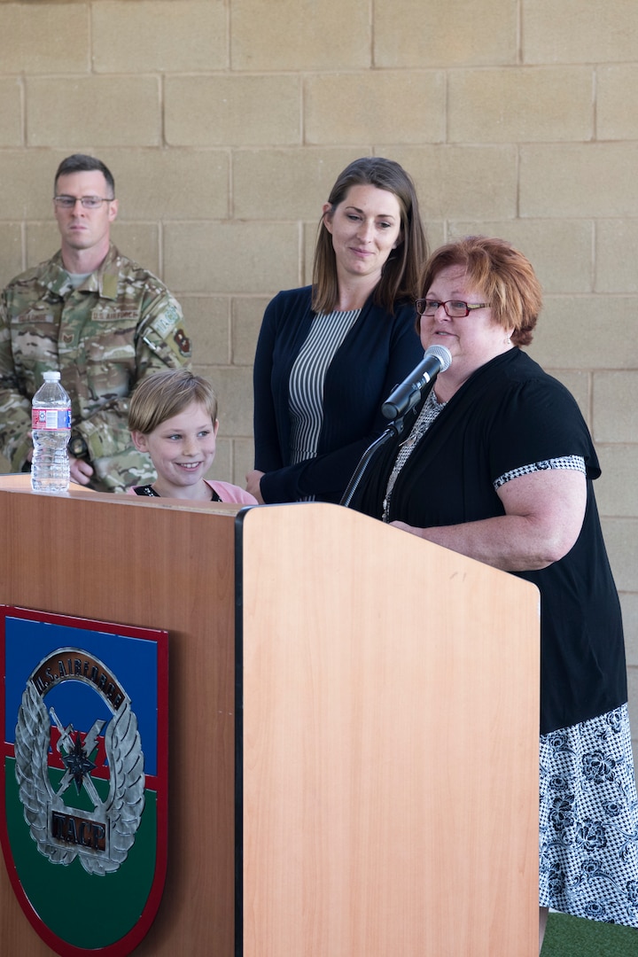 Tiffany Smith (right), wife of Senior Airman Bradley Smith, a Silver Star recipient, provides remarks while Smith’s mother, Paula Smith (center) and daughter, Chloe Smith (left), 9, look on during a dedication ceremony in Smith’s honor at Joint Base San Antonio-Lackland Medina Annex, Texas.