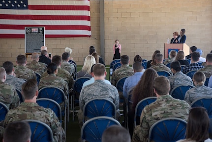 Chloe Smith (center), 9, sings a song she wrote about her father, Senior Airman Bradley Smith, a Silver Star recipient, that provoked emotions in the listeners during a dedication ceremony in Smith’s honor at Joint Base San Antonio-Lackland Medina Annex, Texas.