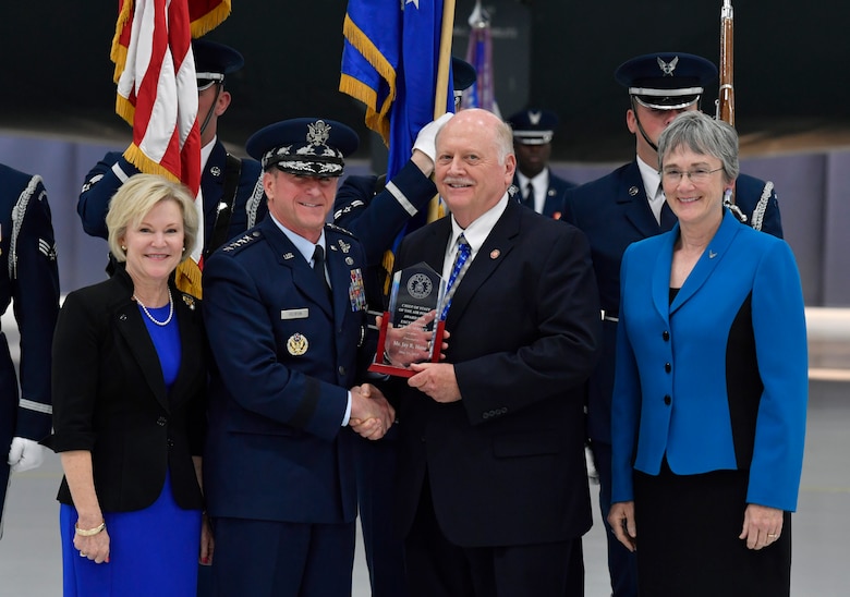 Jay Hone, spouse of Secretary of the Air Force Heather Wilson, is presented an award by Air Force Chief of Staff Gen. David L. Goldfein during the SECAF's farewell ceremony at Joint Base Andrews, Md., May 21, 2019. (U.S. Air Force photo by Wayne Clark)