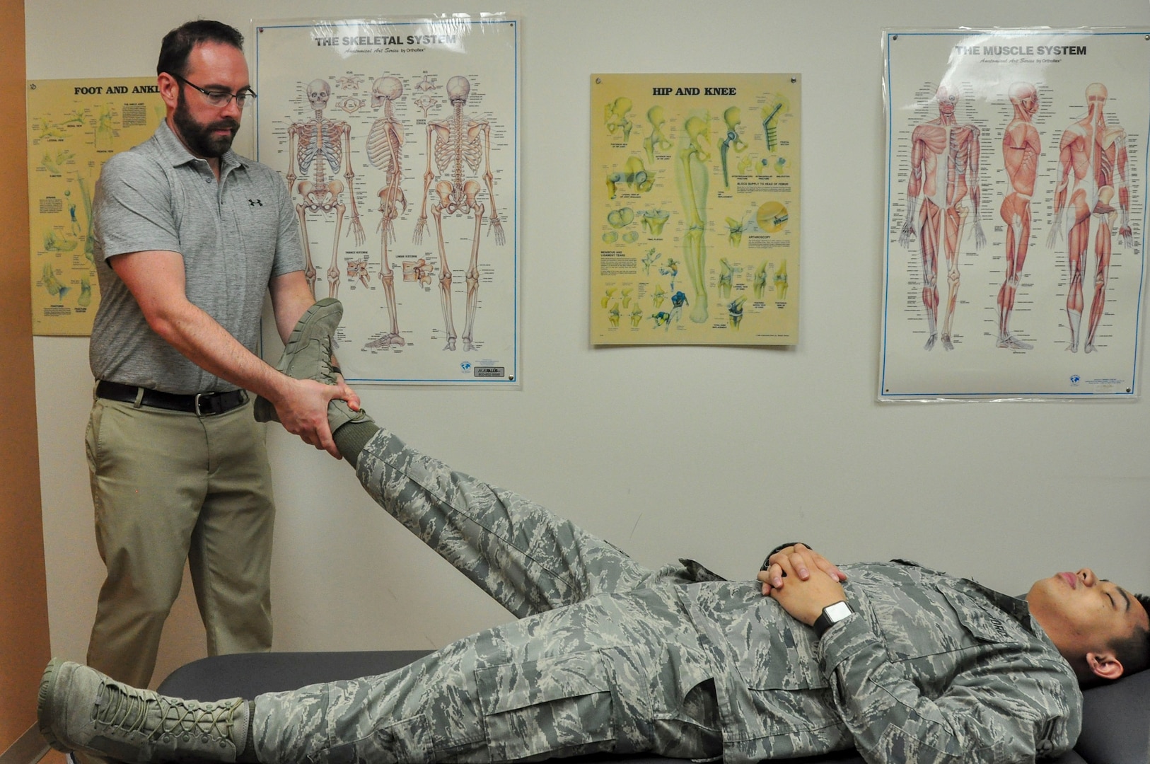 Dr. Jason Wheeler, 359th Medical Operations Squadron Physical Therapy Flight physical therapist, performs hip manipulation on Airman 1st Class Albert Lapera, 359th Medical Group physical therapy technician, to demonstrate one type of physical therapy used to help patients with arthritis. Arthritis Awareness Month, which is observed in May, is a time to motivate people, especially those with arthritis, to become more physically active.