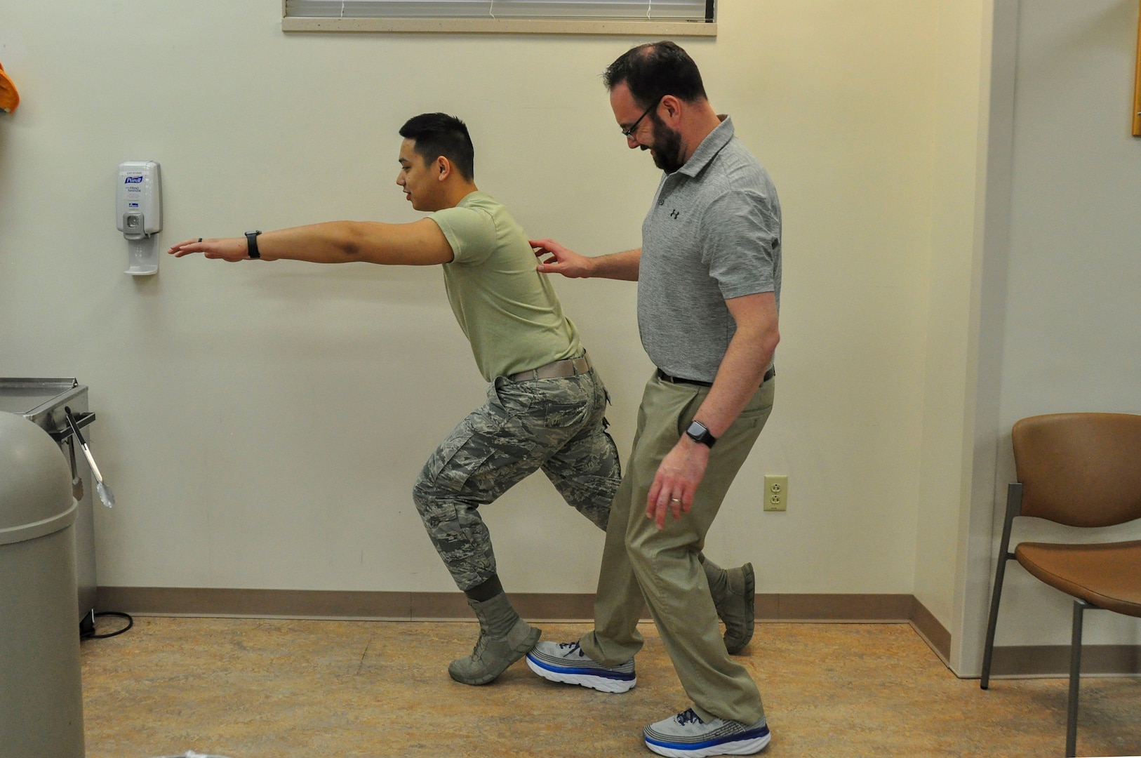 Dr. Jason Wheeler, 359th Medical Operations Squadron Physical Therapy Flight physical therapist, repositions the foot of Airman 1st Class Albert Lapera, 359th Medical Group physical therapy technician, as he does a sneaky lunge, an exercise used to help patients with balance. Arthritis Awareness Month, which is observed in May, is a time to motivate people, especially those with arthritis, to become more physically active.