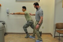 Dr. Jason Wheeler, 359th Medical Operations Squadron Physical Therapy Flight physical therapist, repositions the foot of Airman 1st Class Albert Lapera, 359th Medical Group physical therapy technician, as he does a sneaky lunge, an exercise used to help patients with balance. Arthritis Awareness Month, which is observed in May, is a time to motivate people, especially those with arthritis, to become more physically active.