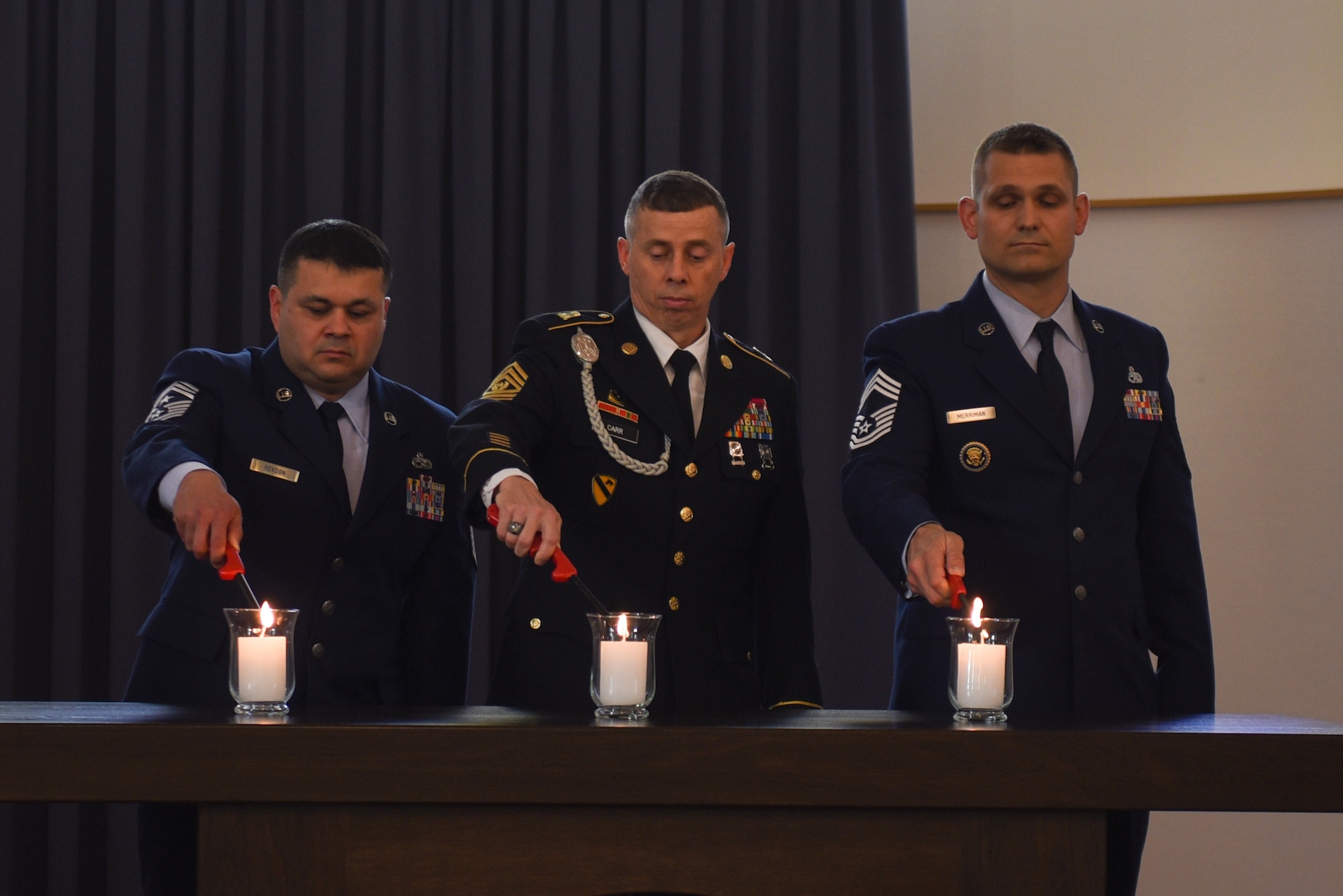 Kaiserslautern Military Community senior enlisted leaders light candles to remember the 451 children lost between 1952 and 1971 at Daenner Kaserne Chapel on Daenner Kaserne, Germany, May 19, 2019. The Kindergraves memorial service is held annually to honor the children. (U.S. Air Force photo by Airman 1st Class Kaylea Berry)