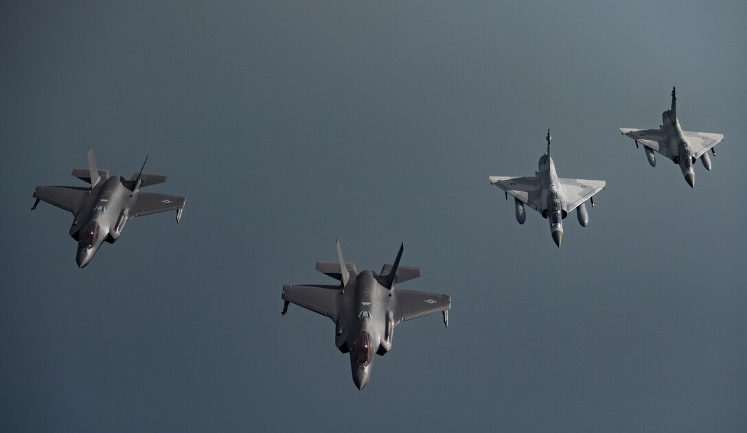 Qatar Emiri Air Force (QEAF) Mirage 2000s and U.S. F-35A Lightning IIs fly in formation over Southwest Asia, May 21, 2019. This flight continues building on interoperability and military-to-military relationships with the QEAF. (U.S. Air Force photo by Senior Airman Keifer Bowes)