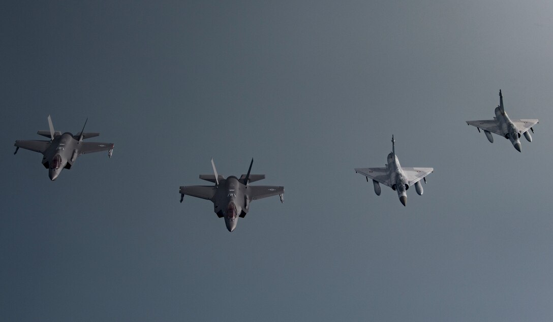 Qatar Emiri Air Force (QEAF) Mirage 2000s and U.S. F-35A Lightning IIs fly in formation over Southwest Asia, May 21, 2019. This flight continues building interoperability and military-to-military relationships with the QEAF. (U.S. Air Force photo by Senior Airman Keifer Bowes)