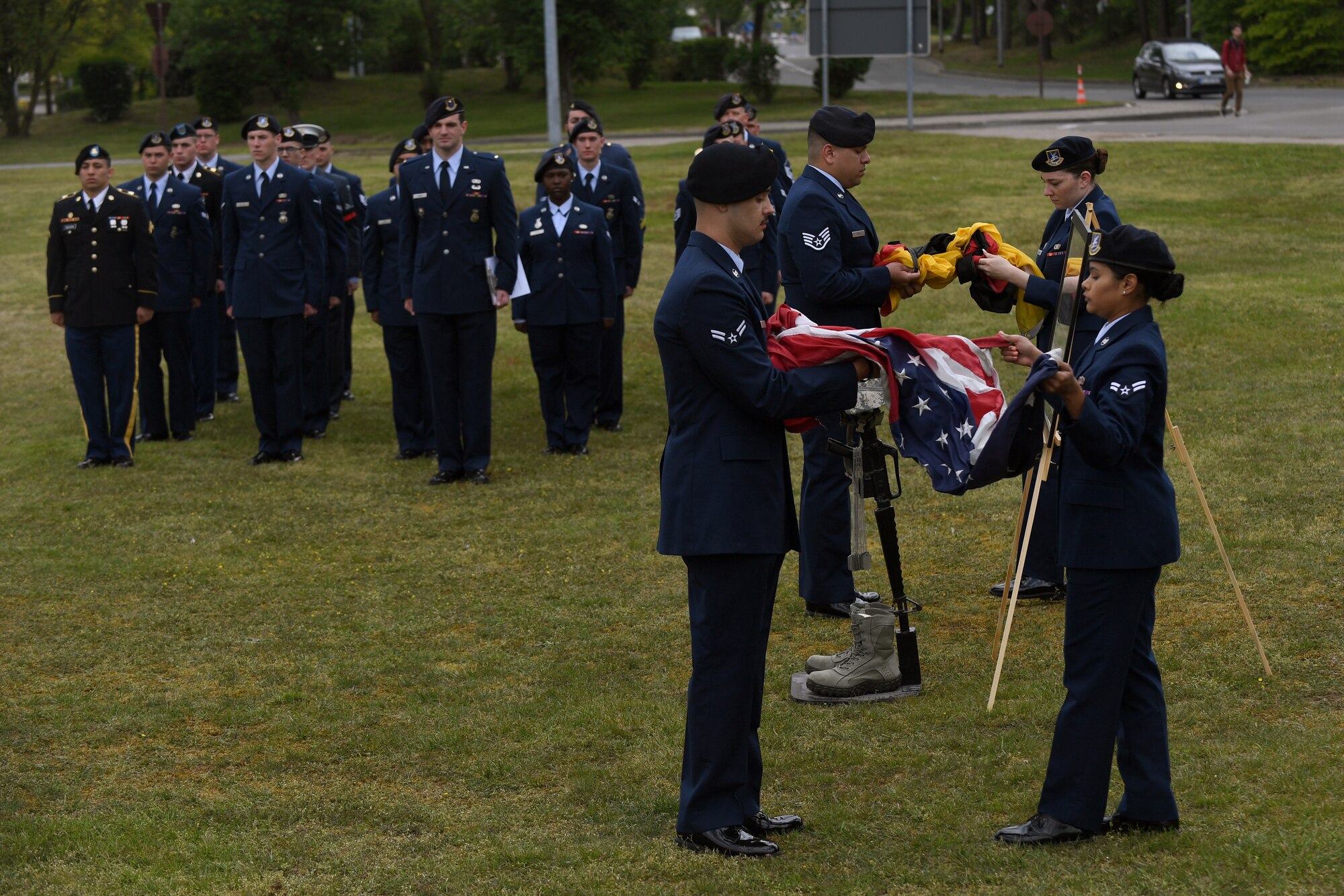 U.S. Airmen fold an American and German flag in recognition of fallen U.S. armed forces police services members during the Police Week 2019 retreat ceremony on Vogelweh Military Complex, Germany, May 17, 2019.