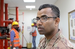 Staff Sgt. Zafar Iqbal, 184th Sustainment Command, observes maintence contractors at Camp Arifjan, Kuwait, Feb. 28, 2019.