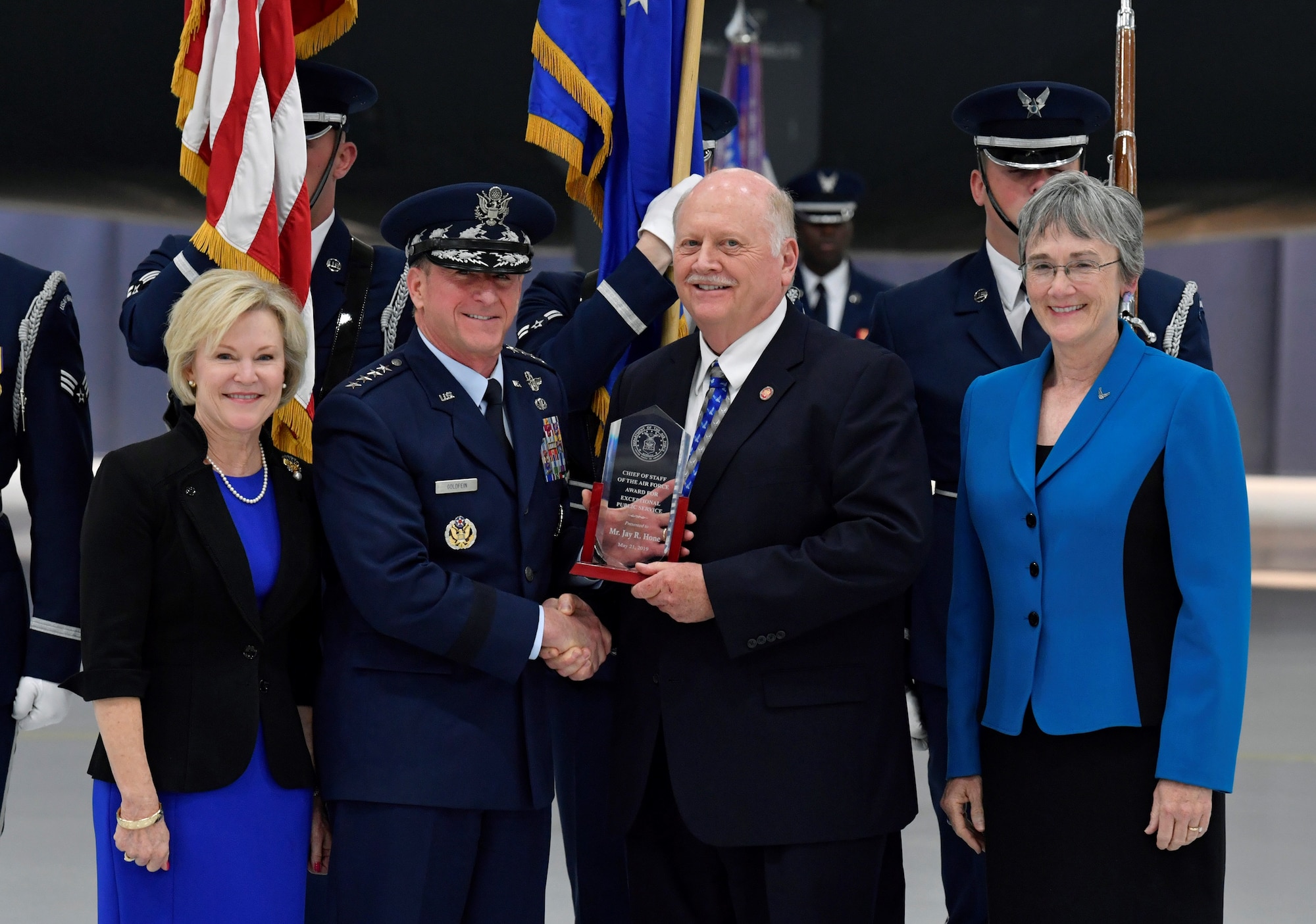Jay Hone, spouse of Secretary of the Air Force Heather Wilson, is presented an award by Air Force Chief of Staff Gen. David L. Goldfein during the SECAF's farewell ceremony at Joint Base Andrews, Maryland, May 21, 2019.