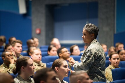 Air Force Chief Master Sgt. Rebecca Baxter, Air Force Personnel Center superintendent of personnel operations directorate, discusses enlisted personnel matters at the AFPC Roadshow Town Hall at the Hercules Theater, May 13, 2019 at Ramstein Air Base, Germany. During the town hall, AFPC briefers spoke to 86th Airlift Wing military and civilians on changes to processes and policies regarding personnel matters.