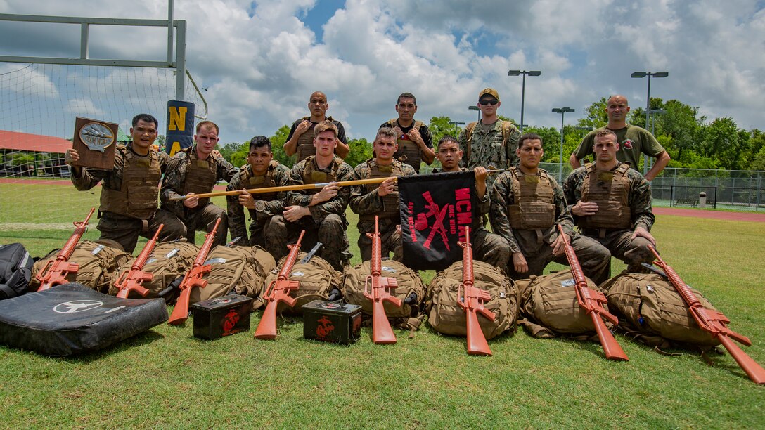 U.S. Marines and Sailor with Martial Arts Instructor Course 1-19 pose for a photo after a combat conditioning exercise at Naval Air Station Joint Reserve Base New Orleans on May 20, 2019. To increase readiness and to support the total force, Reserve and active Marines with Marine Forces Reserve participate in the Martial Arts Instructor Course.  (U.S. Marine Corps photo by Lance Cpl. Jose Gonzalez)