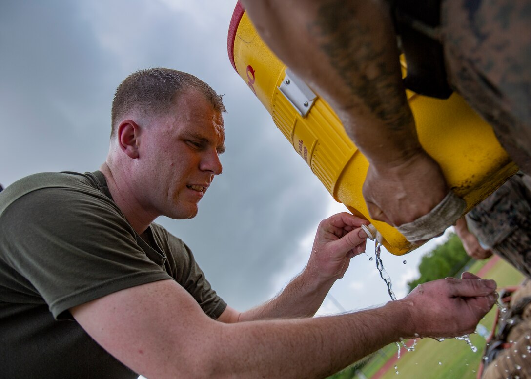 U.S. Marine Corps Sgt. Daultin Love, a ground support equipment instructor with the Center for Naval Aviation Technical Training Unit Jacksonville, Naval Air Station Jacksonville, cools off after a combat conditioning exercise at Naval Air Station Joint Reserve Base New Orleans on May 20, 2019. To increase readiness and to support the total force, Reserve and active Marines with Marine Forces Reserve participate in the Martial Arts Instructor Course.  (U.S. Marine Corps photo by Lance Cpl. Jose Gonzalez)