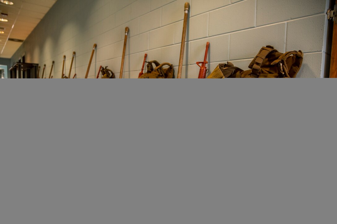 Equipment used in Martial Arts Instructor Course 1-19 lies in a hallway while U.S. Marines participating in the course receive a class at Naval Air Station Joint Reserve Base New Orleans on May 20, 2019. To increase readiness and to support the total force, Reserve and active Marines with Marine Forces Reserve participate in the Martial Arts Instructor Course.  (U.S. Marine Corps photo by Lance Cpl. Jose Gonzalez)