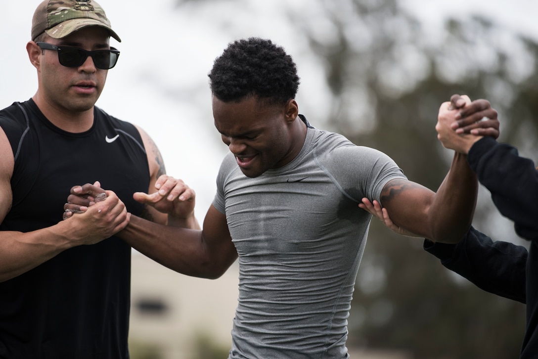 Airman 1st Class Shomari Gervin, 30th Security Forces Squadron defender, is pulled to his feet during the Police Week Warrior Workout of the Day Challenge May 16, 2019, at Vandenberg Air Force Base, Calif. Each competing team of two sprinted between eight workout stations, comprised of various style gym equipment and functional movements while wearing a level-4 plate carrier and had 17 minutes to complete the course. (U.S. Air Force photo by Airman 1st Class Hanah Abercrombie)