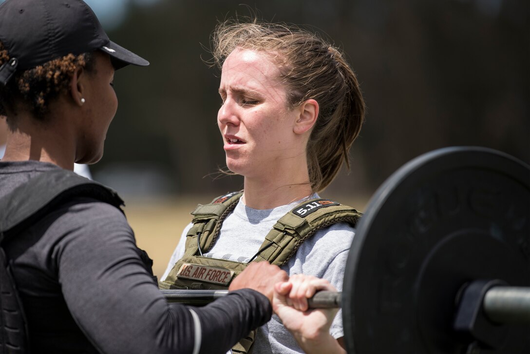 Tech. Sgt. Keisha Waldron, 30th Civil Engineer Squadron Airman dorm leader, and Airman 1st Class Megan Rison, 30th Comptroller Squadron financial manager, participate in the Police Week Warrior Workout of the Day Challenge May 16, 2019, at Vandenberg Air Force Base, Calif. The 30th SFS hosted not only the Warrior WOD challenge, but also a pistol competition, Jail and Bail, Ruck to Remember, Police Expo and candlelight vigil throughout Police Week to honor the men and women of law enforcement. (U.S. Air Force photo by Airman 1st Class Hanah Abercrombie)