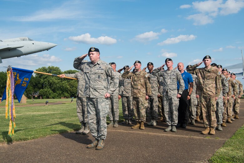 Members of the 633rd Security Forces Squadron stand in formation and salute during the closing ceremony of Police Week at Joint Base Langley-Eustis, Virginia, May 17, 2019. In 1963, President John F. Kennedy signed a proclamation which designated the week of 12-18 May, and the calendar week during which May 15 occurs of each succeeding year, as Police Week. (U.S. Air Force photo by Airman 1st Class Marcus M. Bullock)