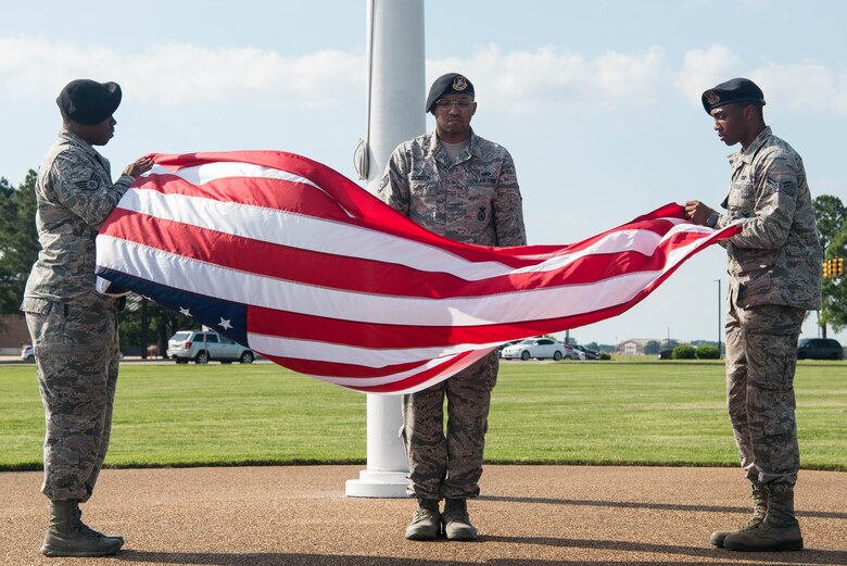 Members of the 633rd Security Forces Squadron fold the United States flag during the closing ceremony of Police Week at Joint Base Langley-Eustis, Virginia, May 17, 2019. The purpose of these events is to honor our defenders, agents, masters at arms, military police, and civilian police officers who made the ultimate sacrifice or have become disabled in the performance of their duties. (U.S. Air Force photo by Airman 1st Class Marcus M. Bullock)