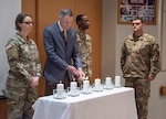 Dr. Steven Rosenblatt, guest speaker, lights a candle to honor the 6 million Jews killed during the Holocaust May 15 during the Days of Remembrance observance at Brooke Army Medical Center at Joint Base San Antonio-Fort Sam Houston. Rosenblatt, the son of a Holocaust survivor, talked about Adolf Hitler's rise to power and his mother's journey as a Holocaust survivor.