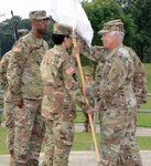 Col. Shauna L. Snyder (right), commander, Medical Professional Training Brigade at Joint Base San Antonio-Fort Sam Houston, passes the unit colors to Command Sgt. Maj. Jennifer A. Redding at an assumption of responsibility ceremony held at the Army Medical Department Museum May 22.