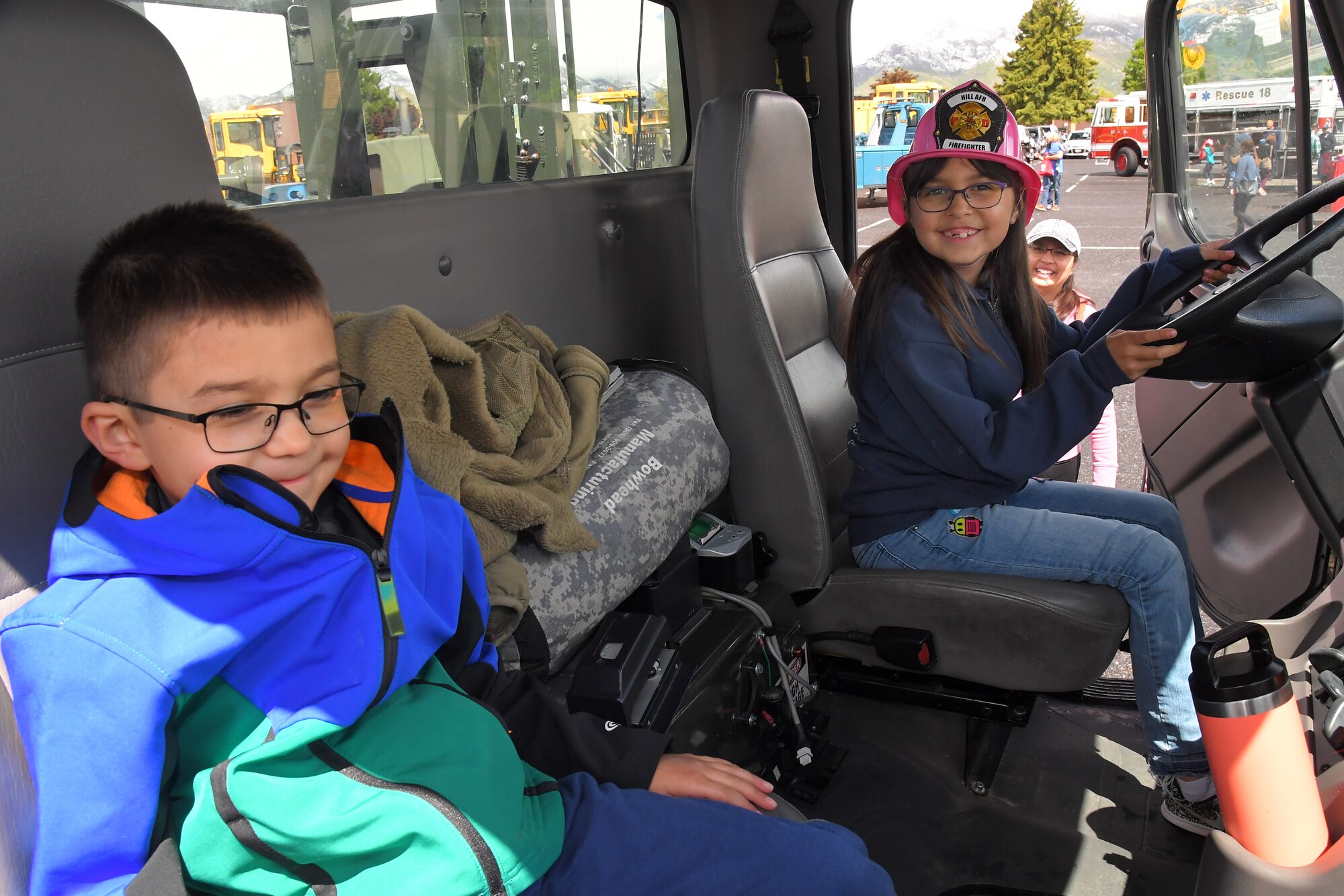 (left to right) Noah and Alina Saunders, enjoy sitting in the cab of a fuels truck at the Wheels of Wonder event, May 17, 2019, Hill Air Force Base, Utah. (U.S. Air Force photo by Todd Cromar)