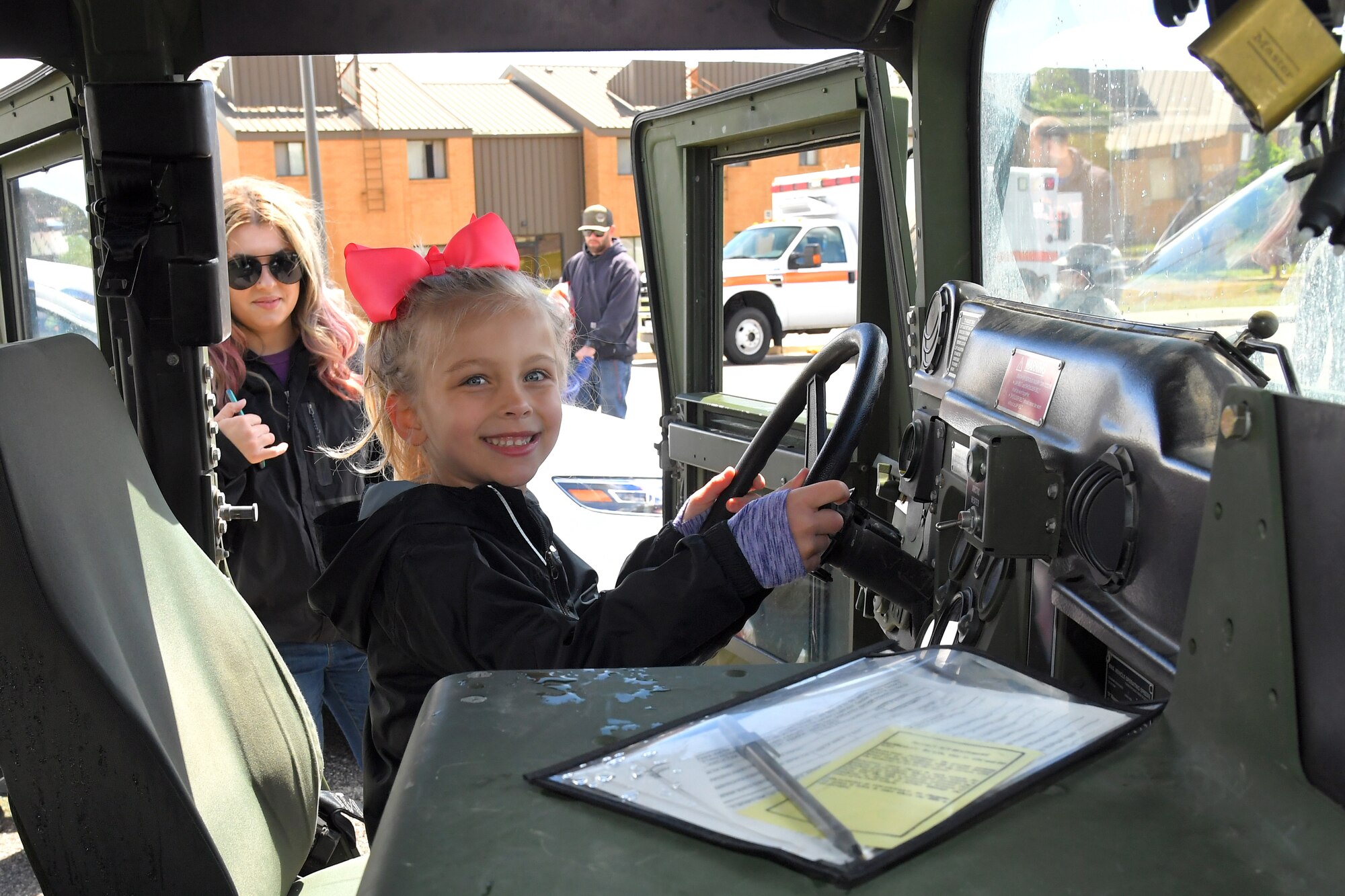 Lila Eccles watches as daughter Zoey Eccles sits in a HUMVEE at the Wheels of Wonder event, May 17, 2019, Hill Air Force Base, Utah. (U.S. Air Force photo by Todd Cromar)