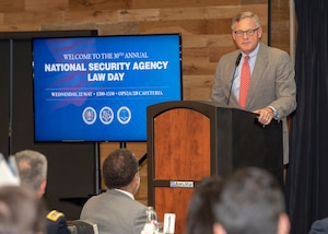 Sen Burr speaks at the podium to NSA employees and guests at 2019 Law Day.