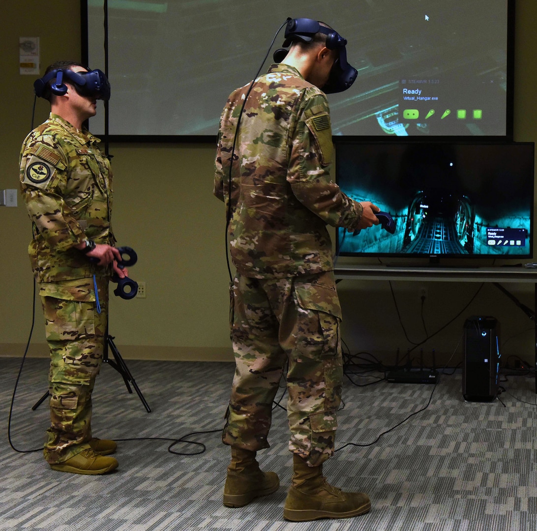 Master Sgt. Ryan Stark (left), 344th Training Squadron special programs manager from Joint Base San Antonio-Lackland, leads U.S. Air Force Staff Sgt. Krystopher Fletcher, 19th Maintenance Group aerospace propulsion instructor, through a virtual reality scenario of the inside of an aircraft May 2, 2019, at Little Rock Air Force Base, Arkansas. Stark and other 344th members TRS visited Little Rock Air Force Base to showcase Integrated Technology Platform, a campaign to use virtual reality to train students using software called Virtual Hangar.