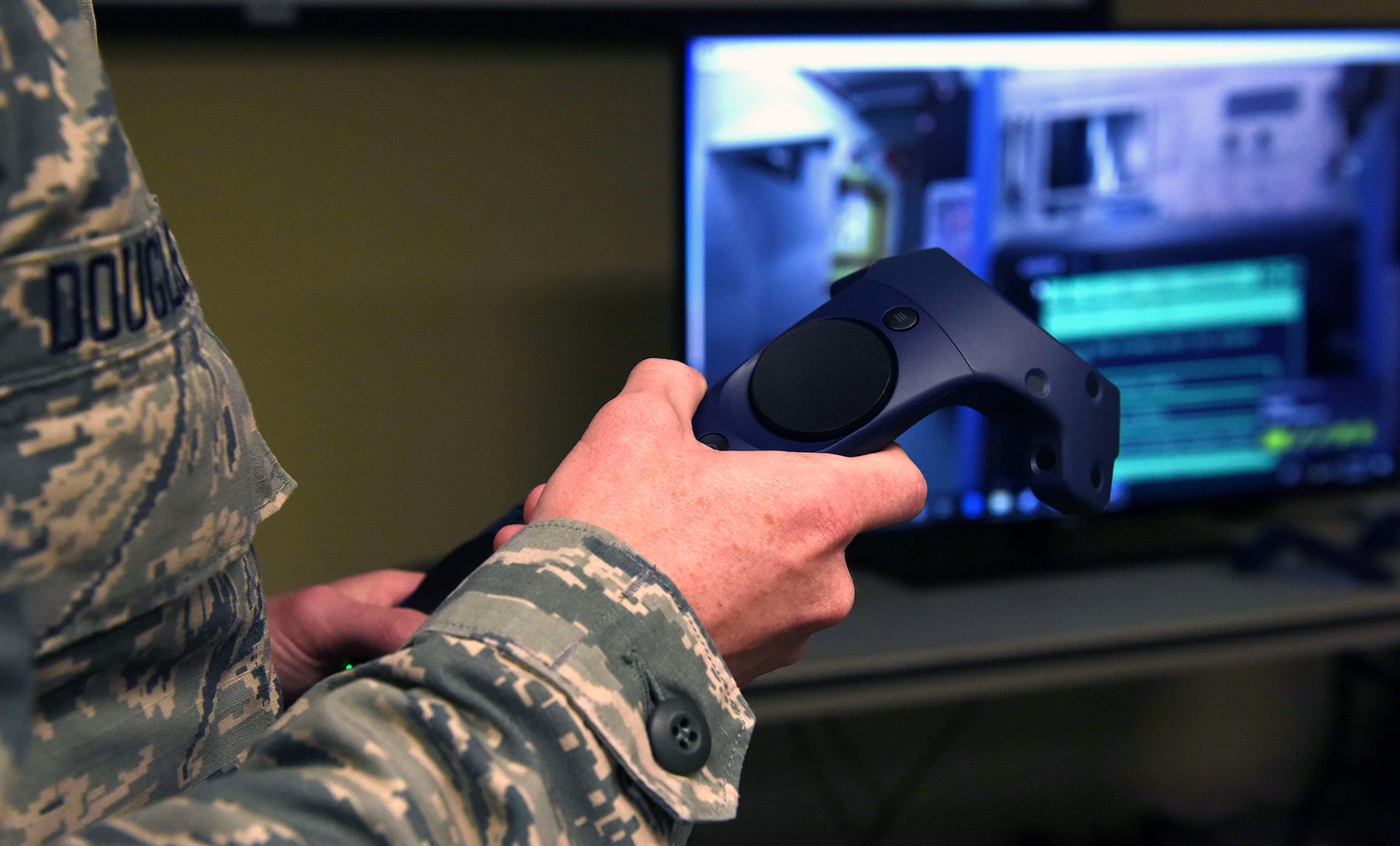 An Airman from the 19th Aircraft Maintenance Squadron communications navigation flight operates a virtual reality controller to complete a scenario May 2, 2019, at Little Rock Air Force Base, Arkansas. Members from the 344th Training Squadron, Joint Base San Antonio-Lackland, came to Little Rock Air Force Base to showcase Integrated Technology Platform, initiative to train students with a virtual reality program called Virtual Hangar. Students can navigate Virtual Hangar using controllers and headsets.