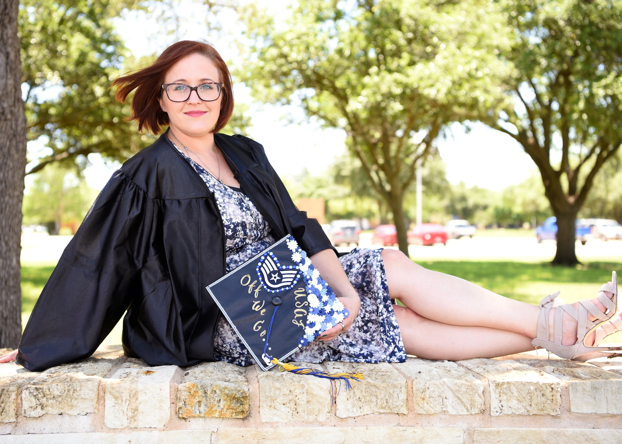 U.S. Air Force Staff Sgt. Britteny Griffith, a 316th Training Squadron linguist instructor at Goodfellow Air Force Base, displays her graduation cap at Angelo State University in San Angelo, Texas, May 8, 2019. Griffith proudly displayed the fact she is an Airman as well as a student with a quote from the “Air Force Song.” (U.S. Air Force photo by Airman 1st Class Ethan Sherwood/Released)