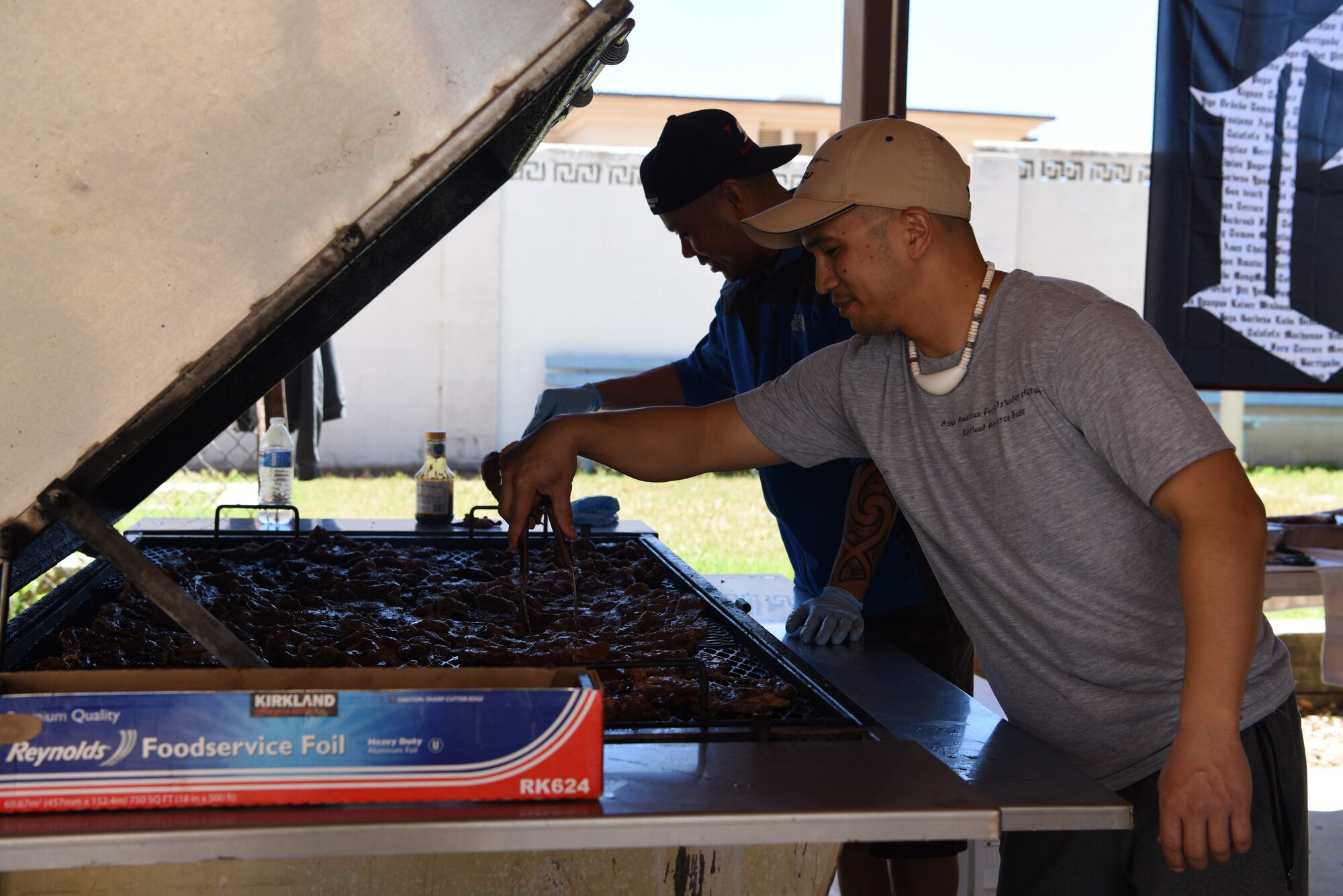 U.S. Air Force Tech. Sgt. Joel Rivera, right, 58th Maintenance Group, and Master Sgt. Jose Estampador, Air Force Nuclear Weapons Center, prepare food for the Asian-American Pacific Islander Heritage Cultural Show and Luncheon at Kirtland Air Force Base, N.M., May 22, 2019. Attendees were provided with a lunch that included grilled beef, lumpia and kalua pork. (U.S. Air Force photo by Senior Airman Eli Chevalier)