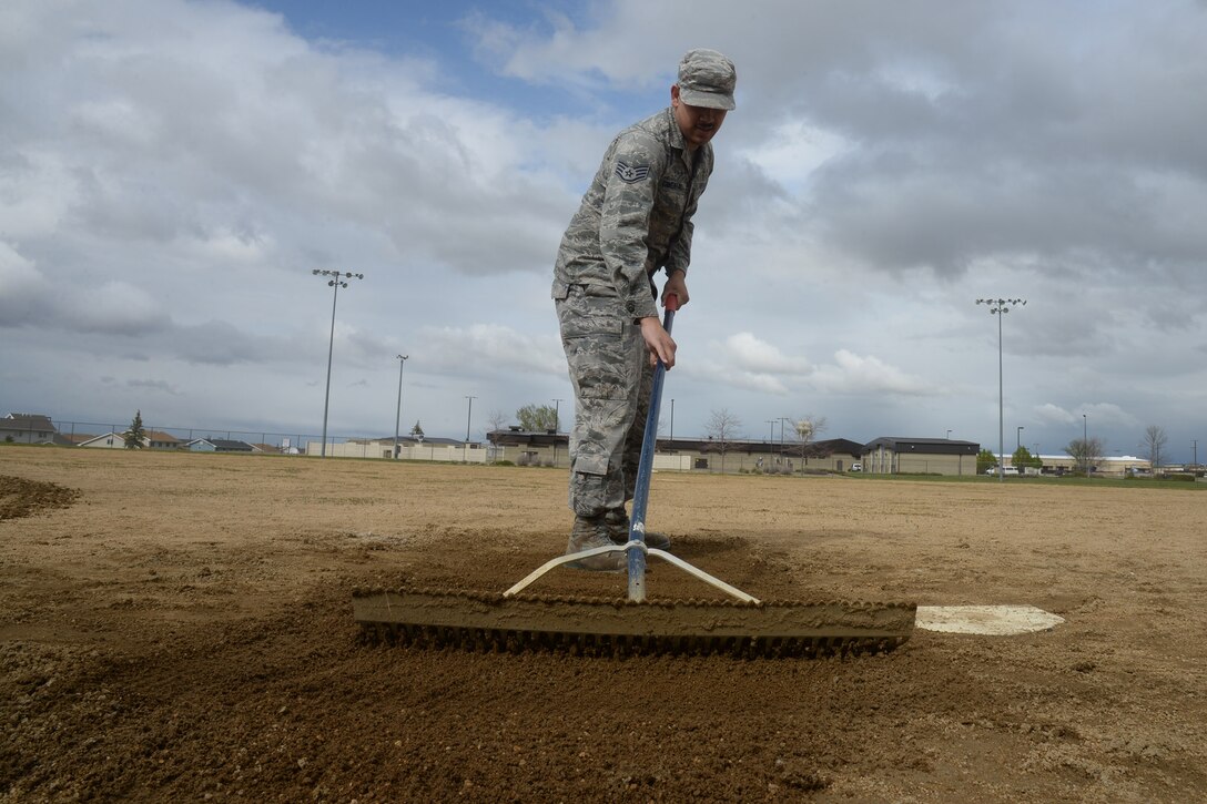 Staff Sgt. Juan Cimental, 341st Force Support Squadron sports program manager, maintains soft dirt on a softball field May 20, 2019, at Malmstrom Air Force Base, Mont.