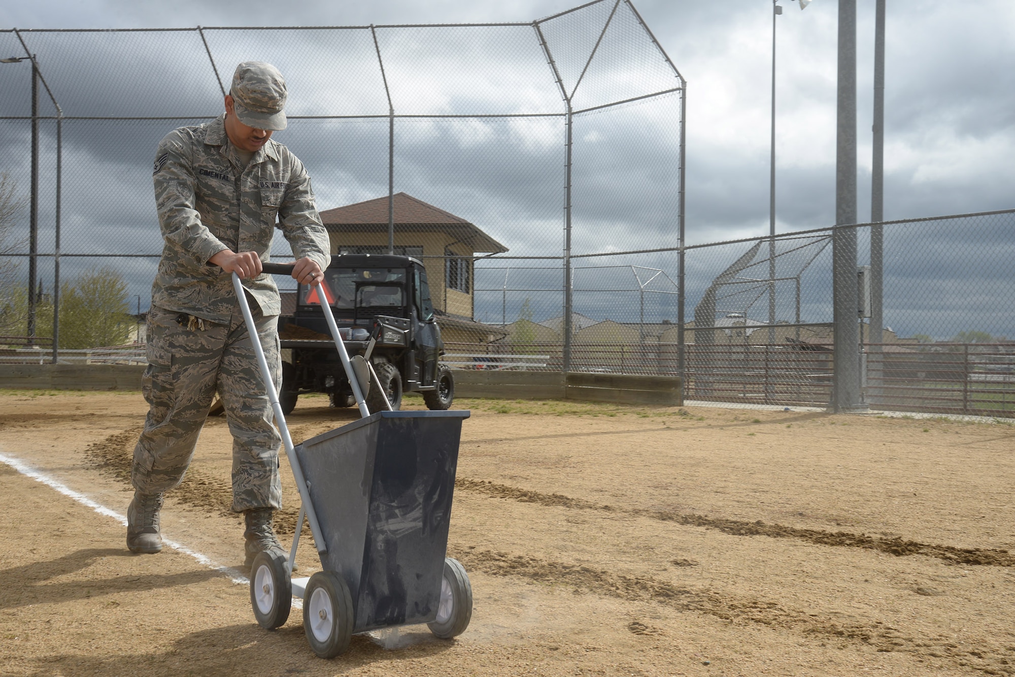 Staff Sgt. Juan Cimental, 341st Force Support Squadron sports program manager, lays down chalk markers on a softball field May 20, 2019, at Malmstrom Air Force Base, Mont.