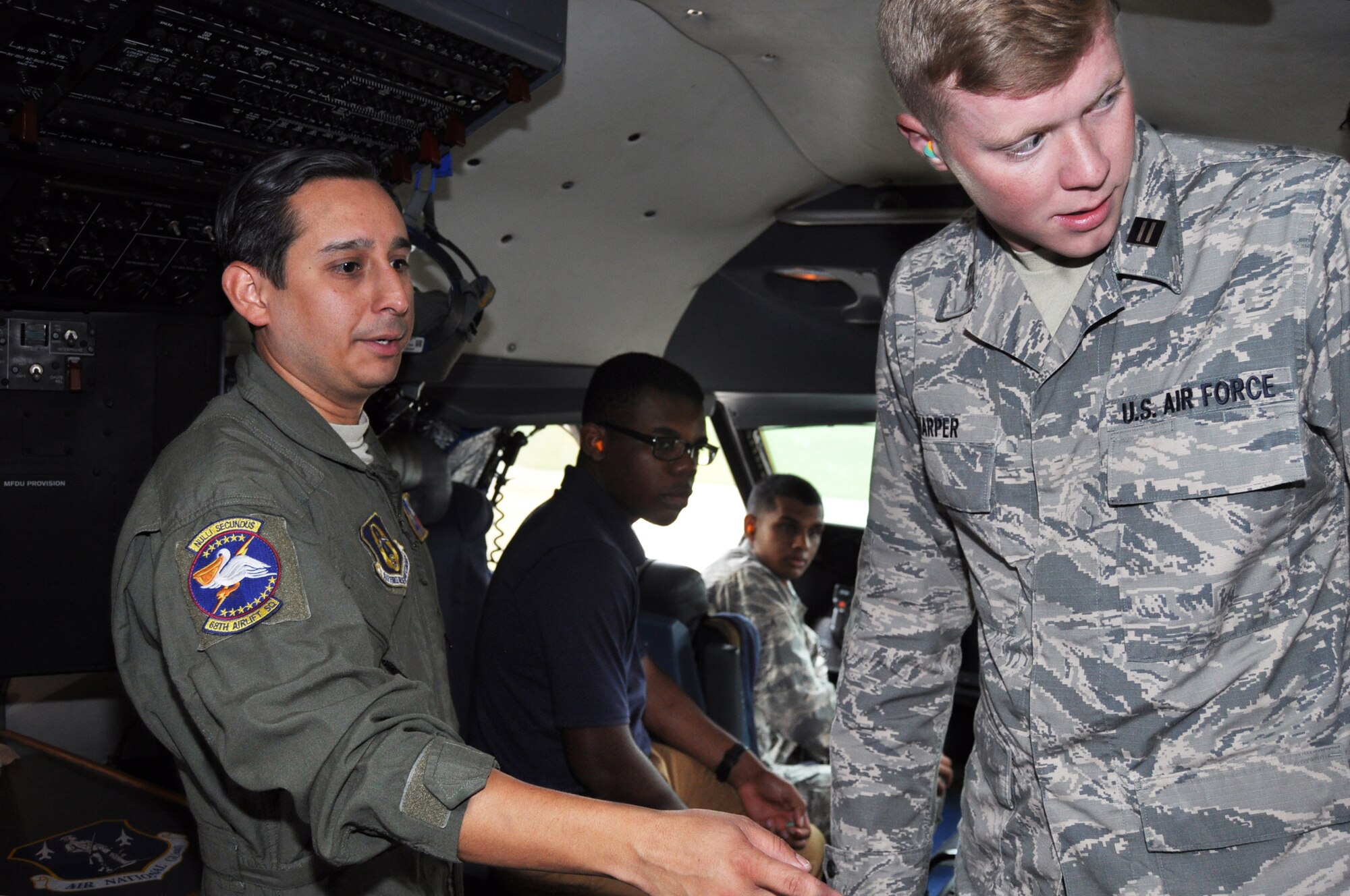 Staff Sgt. Anthony B. Molina, 68th Airlift Squadron flight engineer, briefs University of North Texas Air Force ROTC cadets the functions of some of the components in the C-5M Super Galaxy flight deck, May 16, 2019, at Joint Base San Antonio-Lackland, Texas.