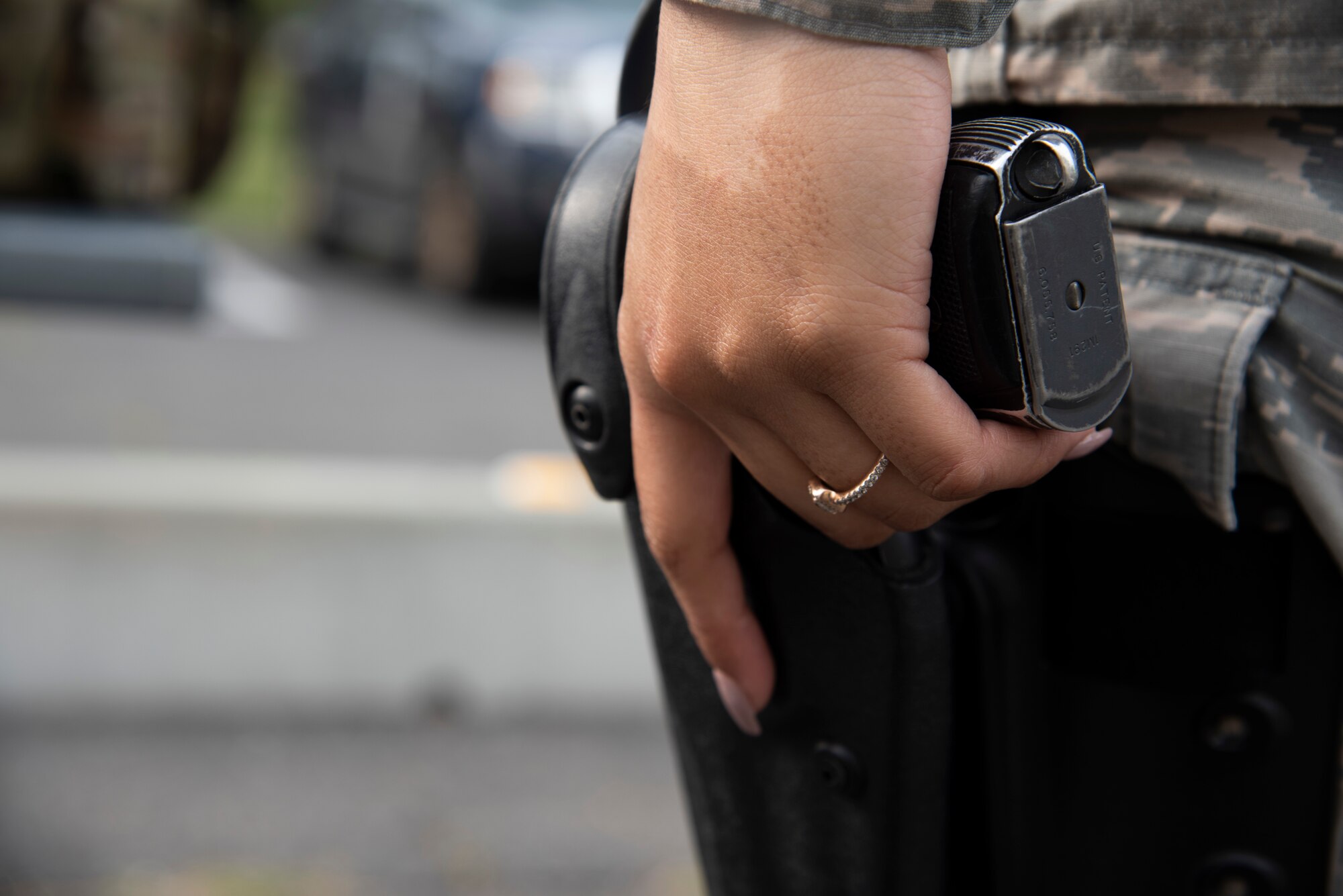 U.S. Air Force Airman 1st Class Aliciana Infante-Crawford, a 35th Security Forces Squadron armory journeyman, holsters a weapon during an armory display at Misawa Air Base, Japan, May 15, 2019. As a security forces member, she is responsible for protecting the U.S. Air Force’s most valuable assets–the lives of their fellow Airmen and aircraft. National Police Week pays special recognition to those who lost their lives in the line of duty for the safety and protection of others. (U.S. Air Force photo by Airman China Shock)