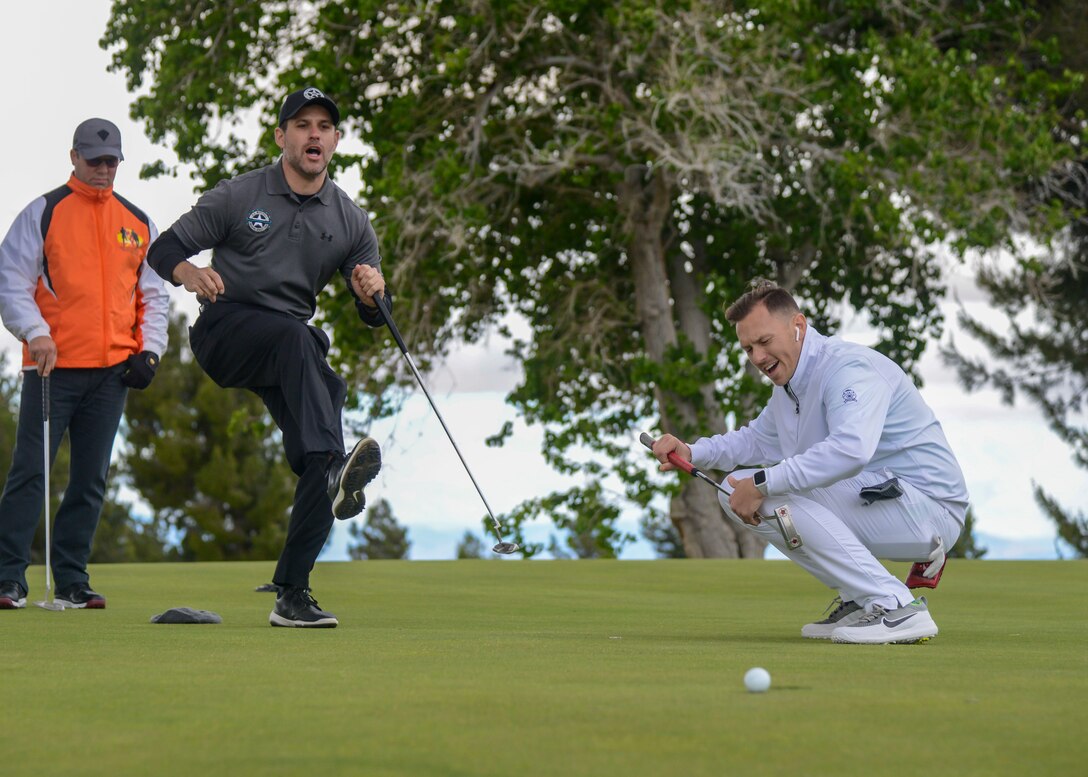 U.S. Marshal Zack Tyler and Joey Gonzalez react in disbelief as Gonzalez’s putt narrowly missed during a golf tournament during Police Week, at Edwards Air Force Base, California, May 14. Police Week is observed May 13-17. (U.S. Air Force photo by Giancarlo Casem)