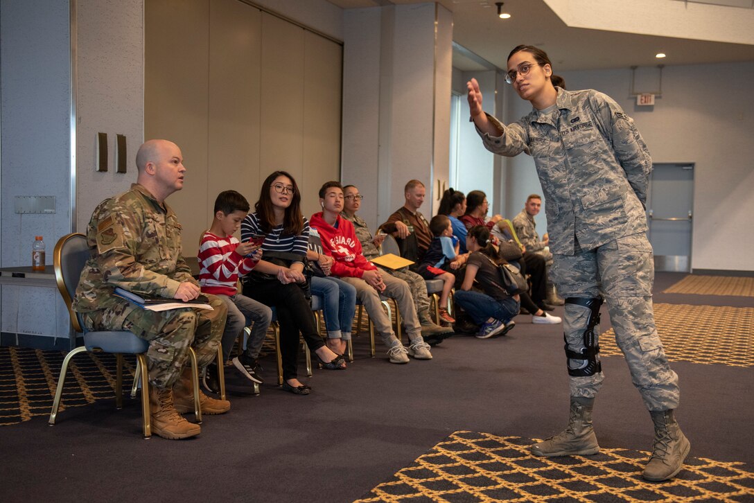 A volunteer directs a family to the correct station during a United States Embassy Outreach event at Yokota Air Base, Japan, May 22, 2019.