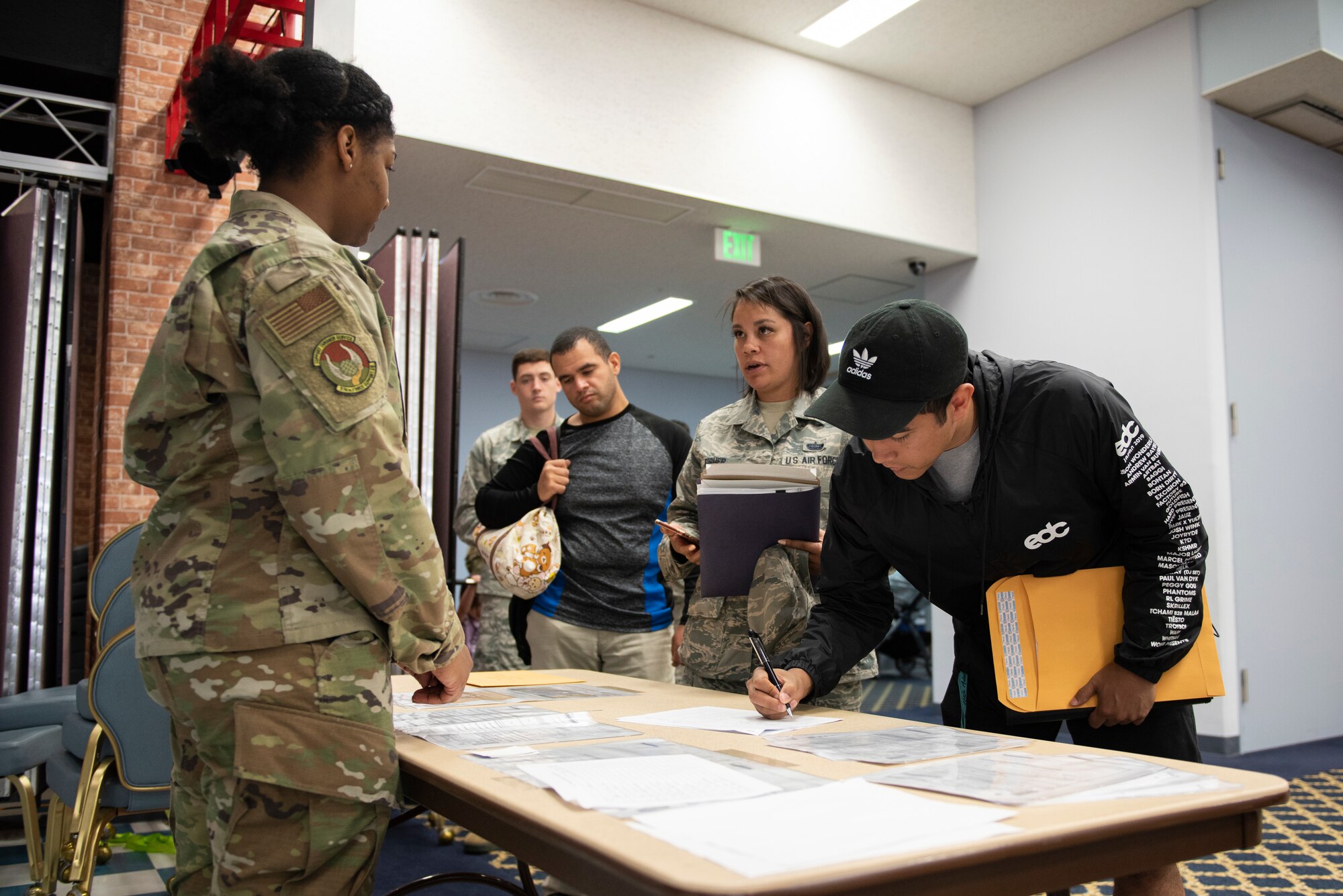 A volunteer answers questions and checks families in at a United States Embassy Outreach event at Yokota Air Base, Japan, May 22, 2019.