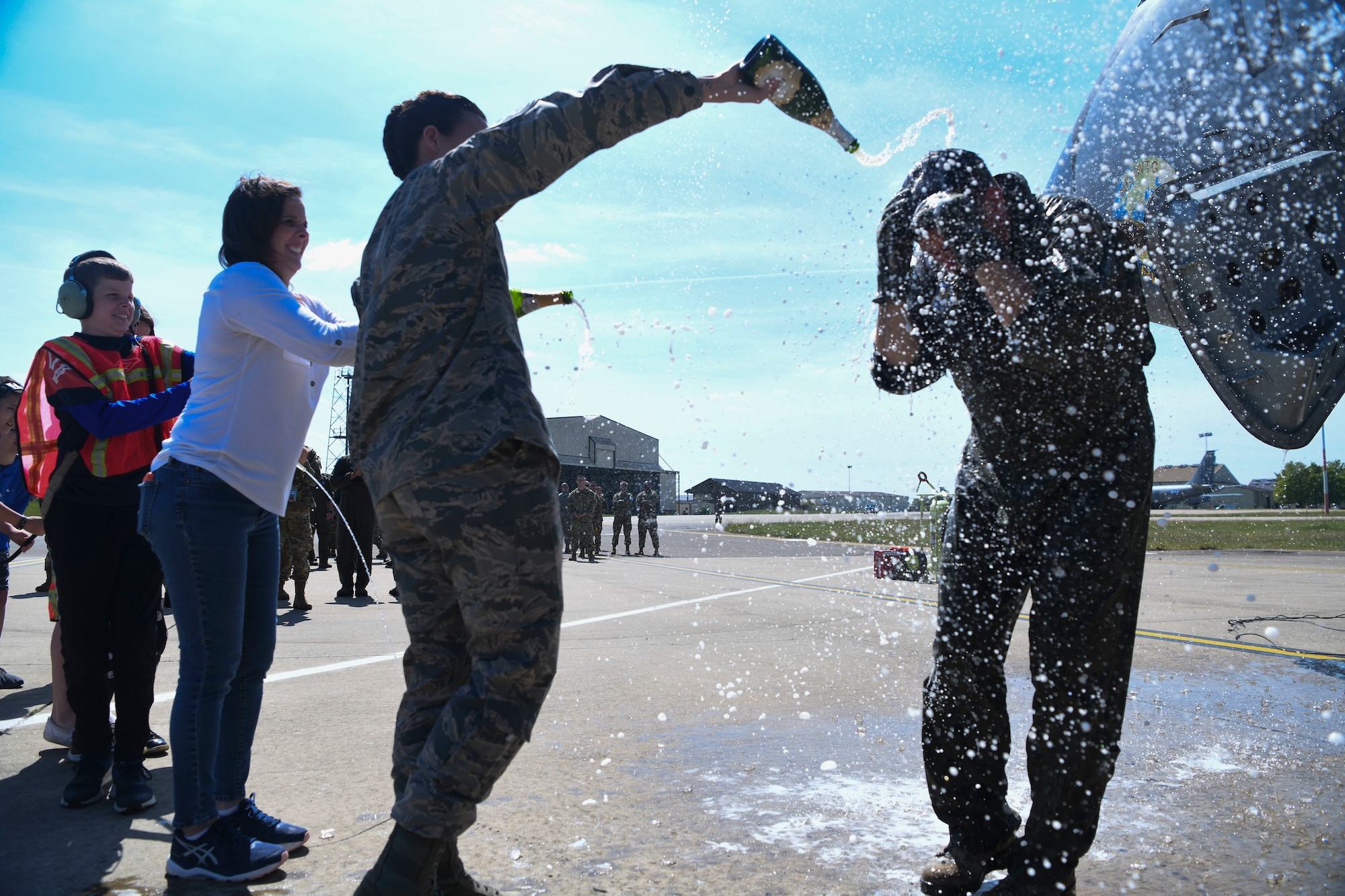 Friends and family of U.S. Air Force Col. Christopher Amrhein, 100th Air Refueling Wing commander, shower him with champagne to celebrate his final flight as commander of 100th ARW at RAF Mildenhall, England, May 15, 2019. Amrhein celebrated his “fini-flight” with family and Chief Master Sgt. Kristina Rogers, 100th ARW Command Chief Master Sergeant. (U.S. Air Force photo by Senior Airman Alexandria Lee)