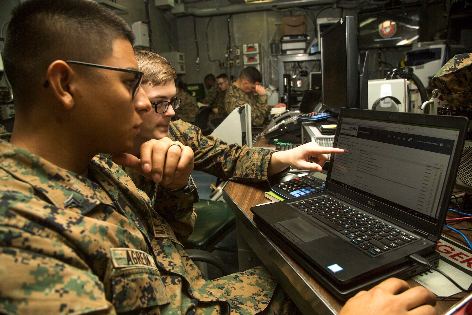 Cpl. Joshua Agreda (left), Supply Marine with 13th Marine Expeditionary Unit, tests the Global Combat Support System-Marine Corps Release 12 upgrade with Sgt. Joel Magee, data specialist with 13th MEU, while deployed before its official launch.