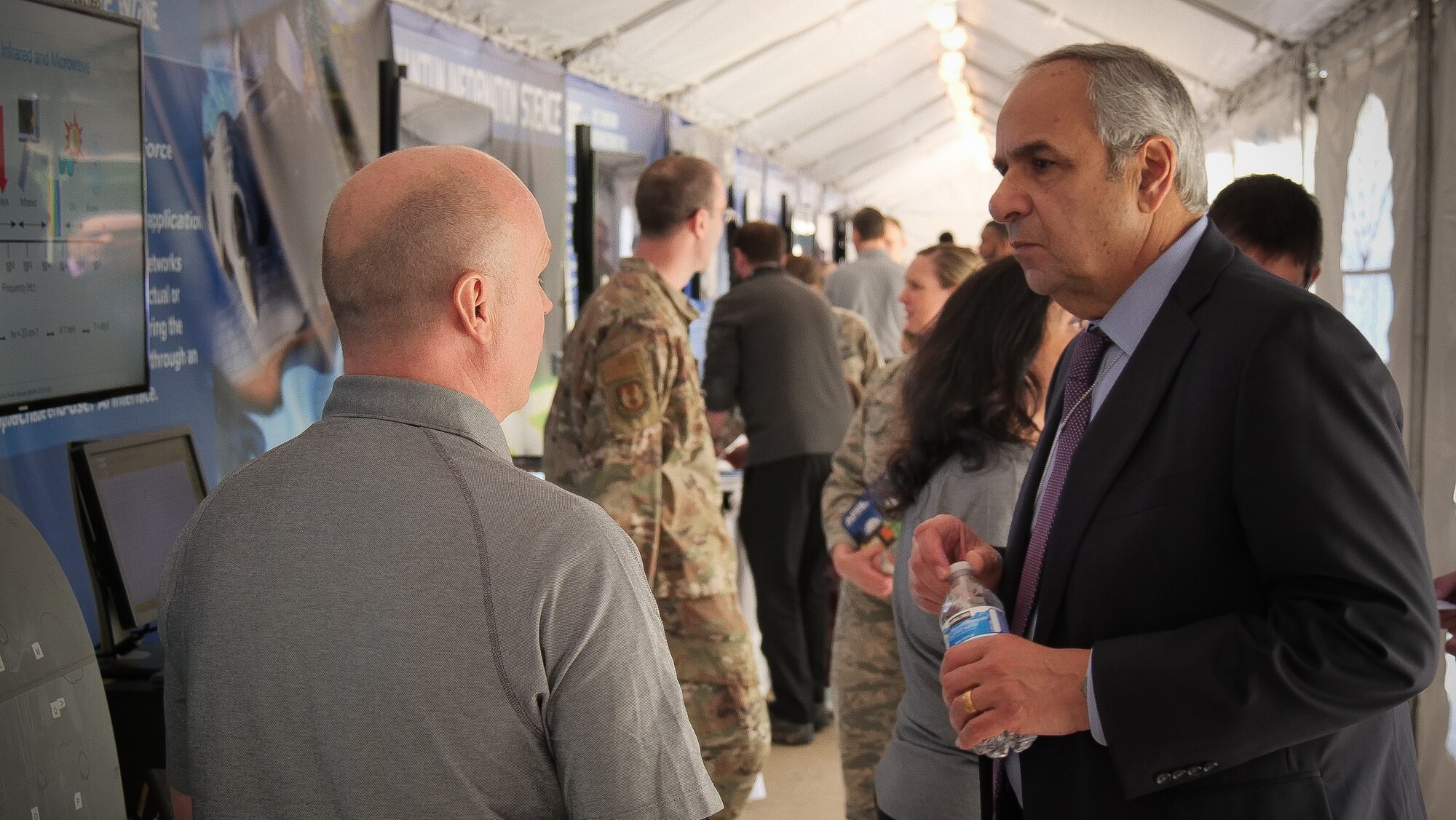 Air Force Chief Scientist Dr. Richard Joseph, right, stopped by DOD Lab Day to learn more about AFRL technologies. Bryan Foos, a materials engineer, explains how the Terahertz Probe, a quality assurance tool, improves aerospace coating measurement capabilities. (U.S. Air Force photo/Keith Lewis)