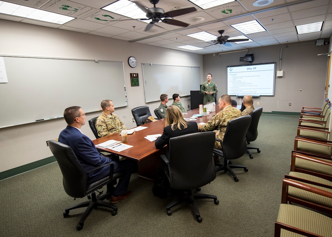 Maj. Christopher Smith, 41st Rescue Squadron (RQS) assistant director of operations, briefs leadership from the 41st RQS along with science and technology advisors from Air Combat Command, May 16, 2019, at Moody Air Force Base, Ga. Dr. John Matyjas and Dr. Donna Joyce visited the 41st RQS to tour and assess their Virtual Reality flight simulator along with taking a fam flight on an HH-60G Pave Hawk. The visit is a part of an Air Force assessment of the possible implementation of VR in training. The 41st RQS VR flight simulator is an initiative that was selected at the Moody Air Force Base 2018 Spark Tank competition. (U.S. Air Force photo by Airman 1st Class Eugene Oliver)
