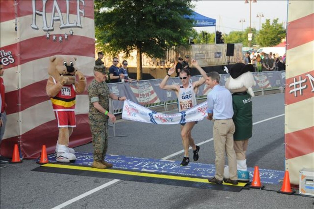 A husband and wife duo earned the top Semper 5ive finishes. Mark Hopely, 30, set a new Semper 5ive course record by two seconds with his top finish of 27:18. Emily Hopely, 32, was the top female finisher with a time of 34:30. The couple shared the awards stage celebrating a shared win in their hometown of Fredericksburg, VA.