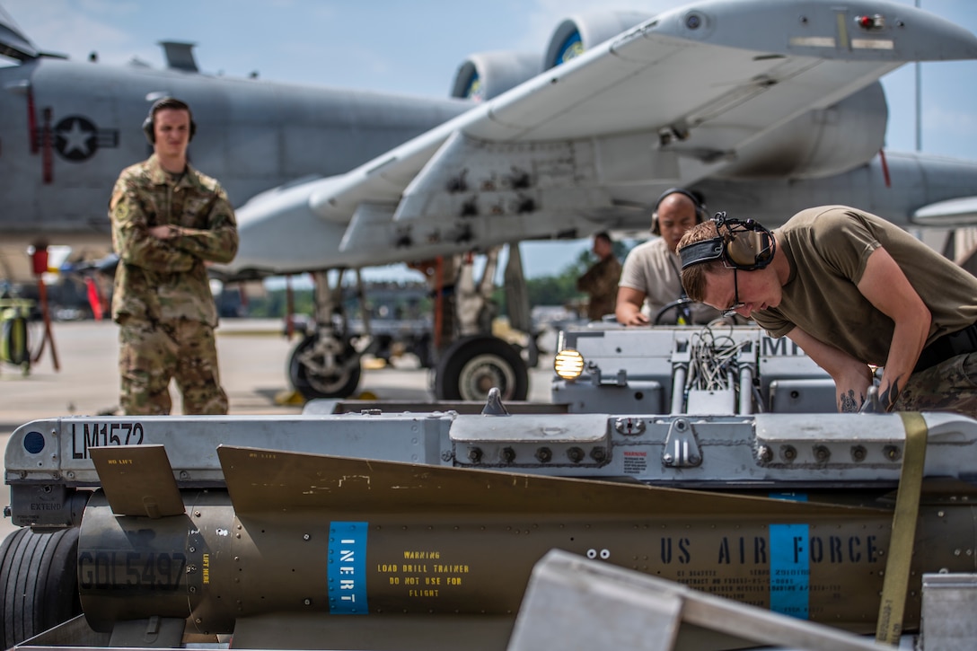 Airmen from the 74th Aircraft Maintenance Unit(AMU) get evaluated while loading May, 22, 2019, at Moody Air Force Base, Ga. The 74th AMU competed in the quarterly weapons load competition against the 75th AMU. (U.S. Air Force photo by Airman 1st Class Joseph P. Leveille)